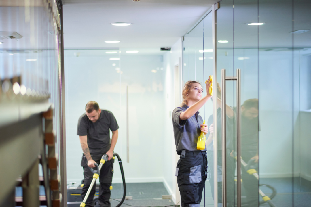 A commercial cleaning team detailing a modern office space